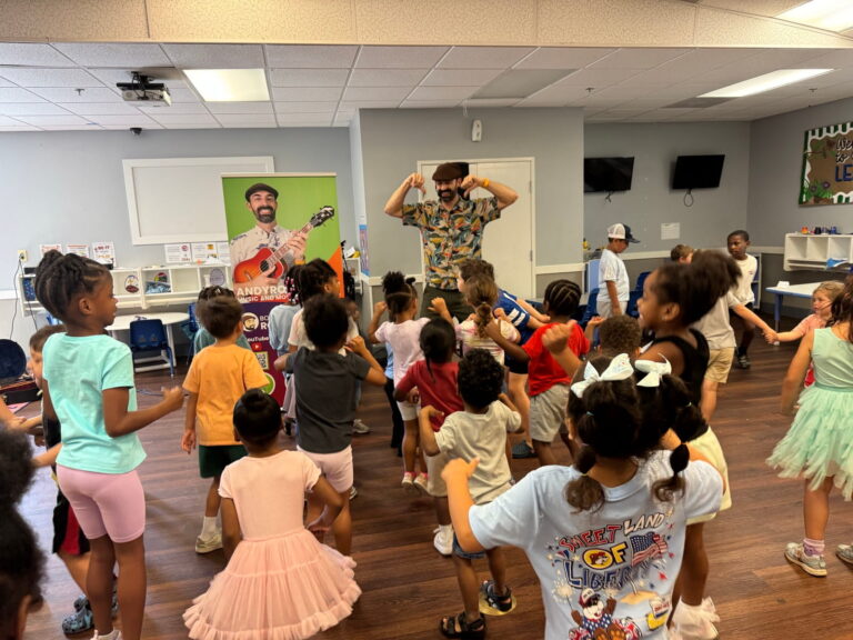 Children dancing together at a music and movement session